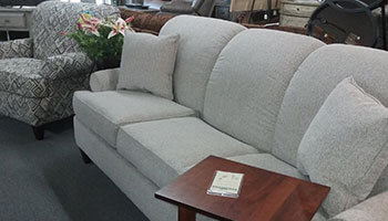 Grey contemporary sofa and patterned arm chair